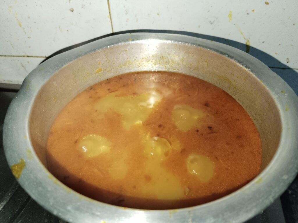 yellow turmeric rice cooking in one pot with potato pieces and spices