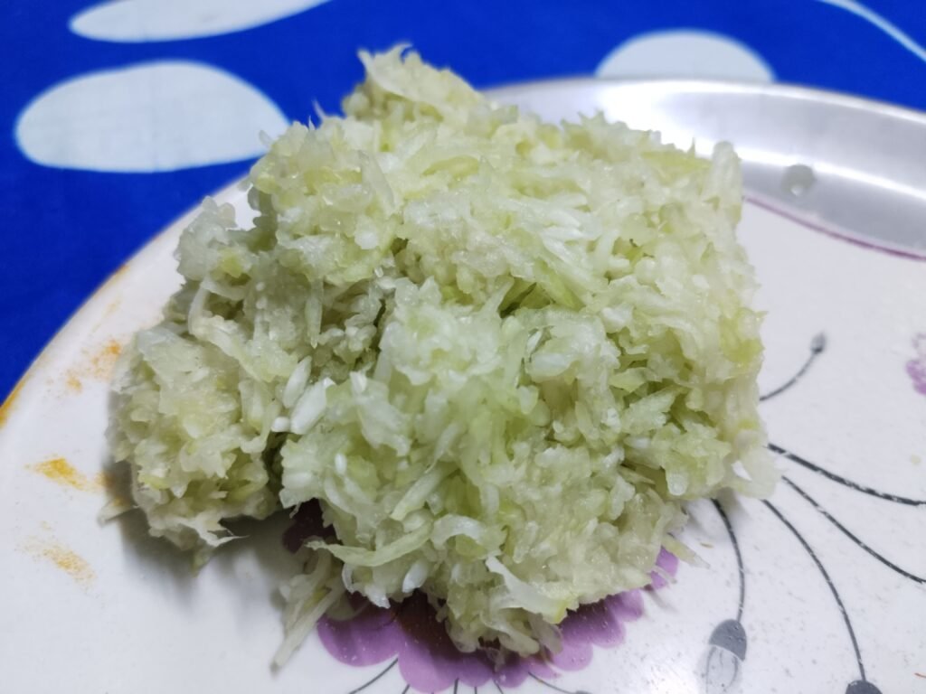 grated bottle gourd squeezed into mound with all water removed ready for bottle gourd balls recipe