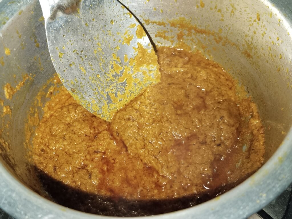 orange golden gravy base cooking in pot after water added 