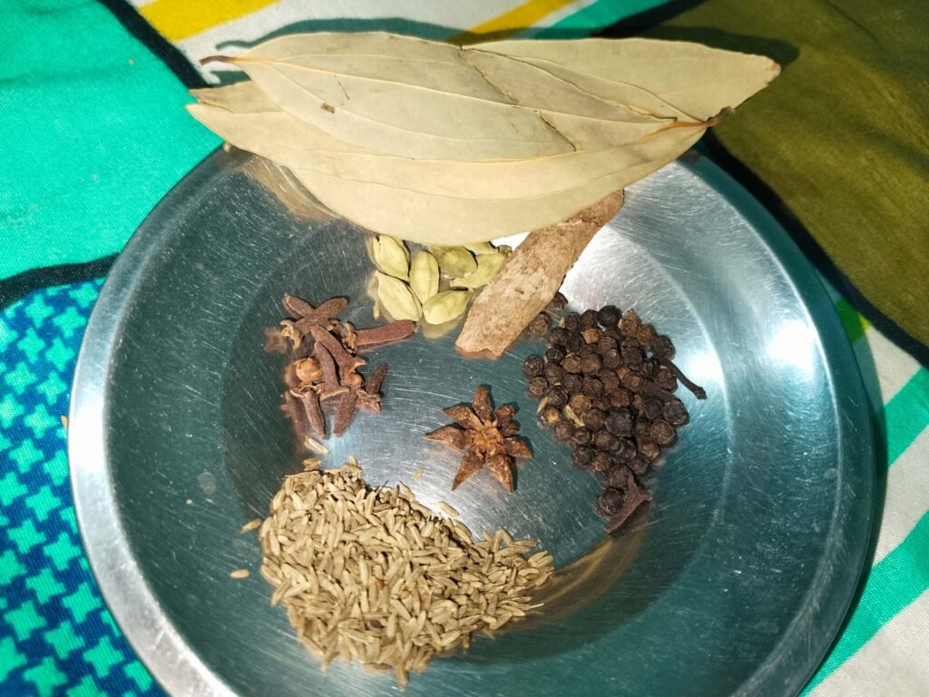 complete whole spice plate with Indian bay leaves added ready for white creamy chicken recipe cooking pot