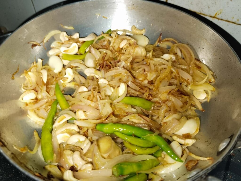 onion cashew garlic ginger mixture getting more golden in pan for white creamy chicken recipe paste base