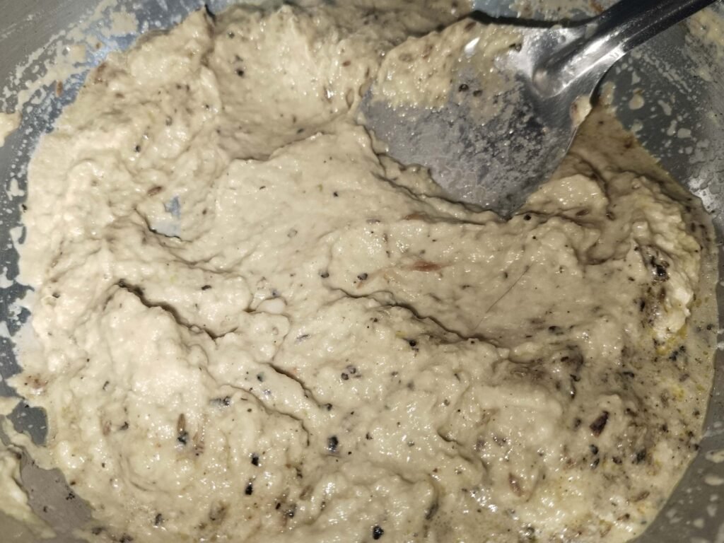 fully golden onion cashew mixture in pan after cooking ready for water before grinding for white creamy chicken recipe