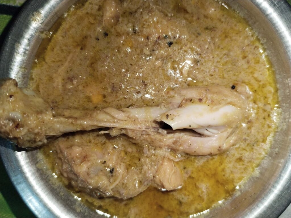 white creamy chicken recipe finished in pale golden creamy gravy in pot ready to serve