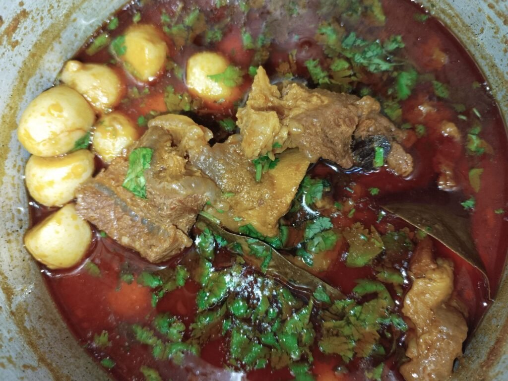 taro beef stew recipe cooked in pot with beef pieces taro and fresh coriander garnish