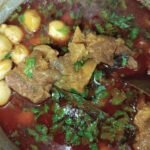 taro beef stew recipe cooked in pot with beef pieces taro and fresh coriander garnish
