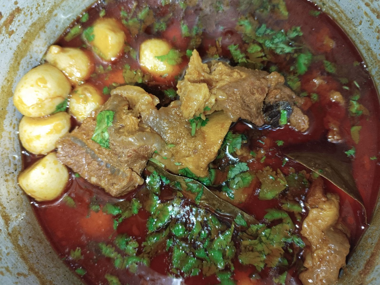 taro beef stew recipe cooked in pot with beef pieces taro and fresh coriander garnish